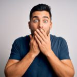 man covers mouth in shock at dirty things he said
