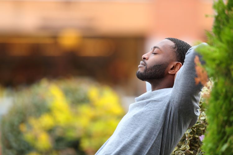 moment for yourself man relaxes on park bench tranquil self-care