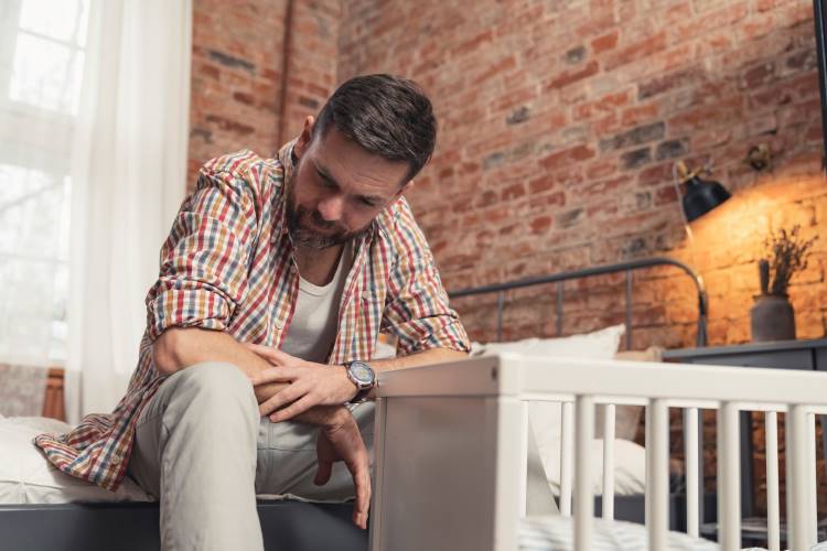 parental anxiety worried dad father crib