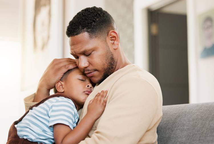 paternal anxiety worried father comforts child