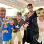 Lance Somerfeld and son surrounded by zombies at Six Flags Great Adventure Fright Fest 2019