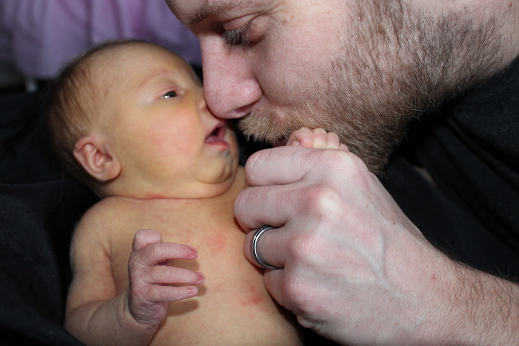 father hold and kissing his daughter on the hand