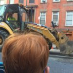 boy watching front loader