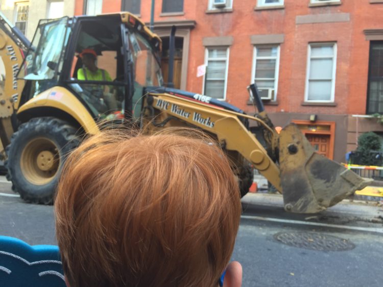 boy watching front loader