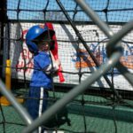 kid swings in batting cage