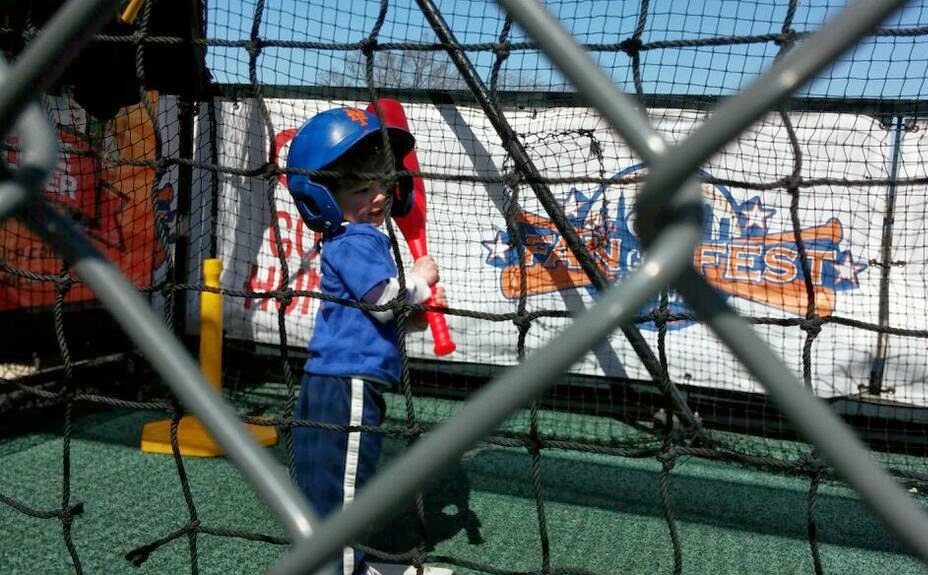 kid swings in batting cage