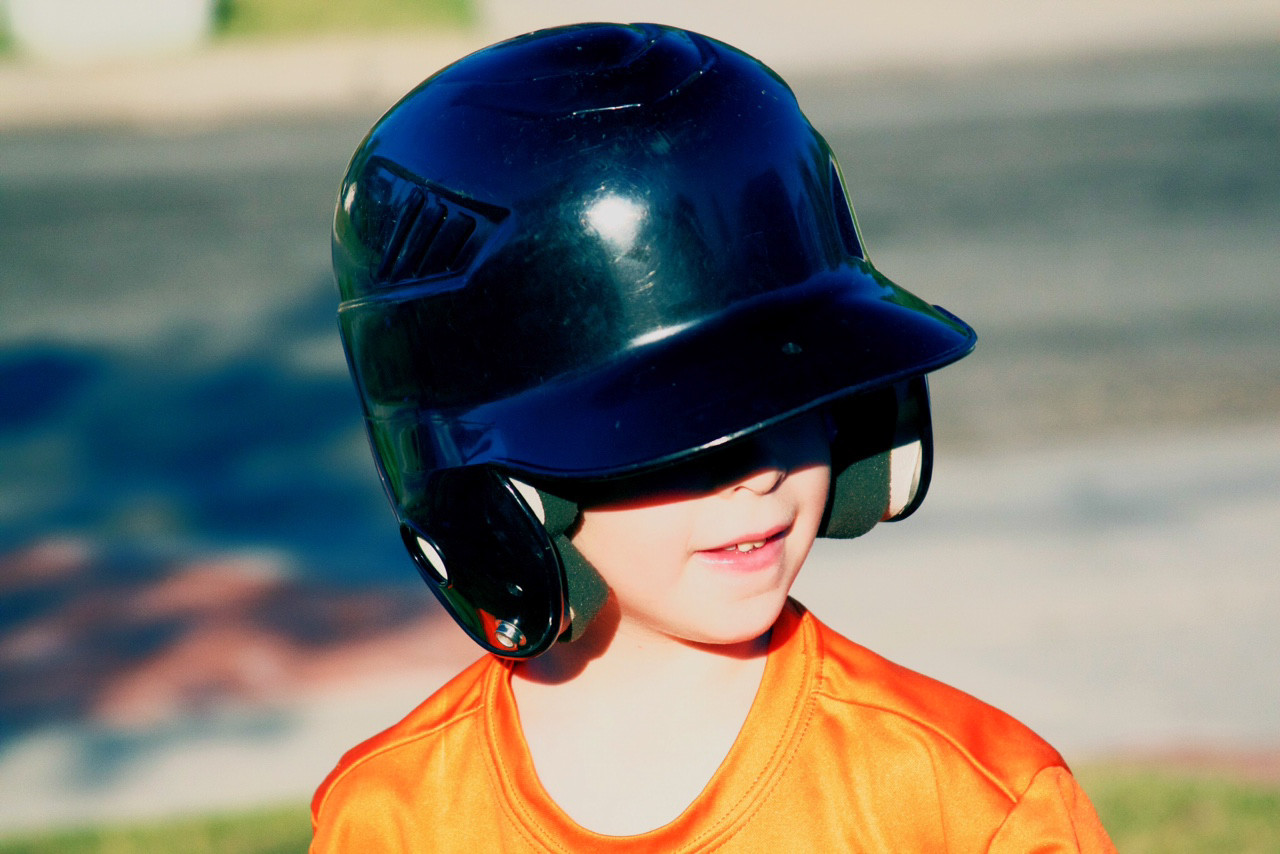 Child wearing a baseball helmet