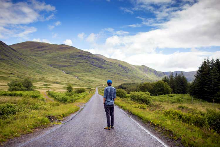 man stares up hill the long road to adulthood