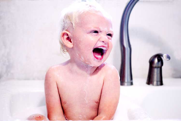 baby in tub taking a bath