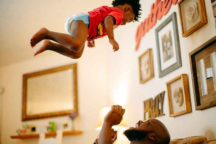 beleaf melanin tosses his child in the air