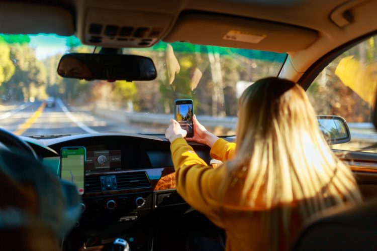 best road trip apps family car passenger takes photo