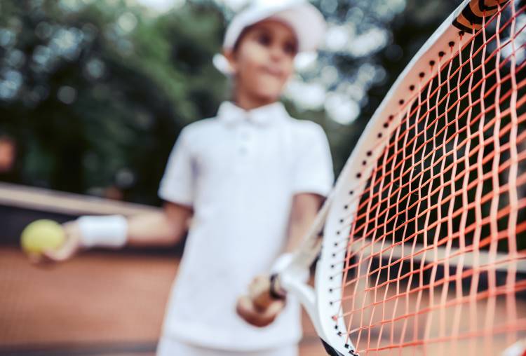 child playing tennis racket
