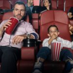 dad son at movies popcorn