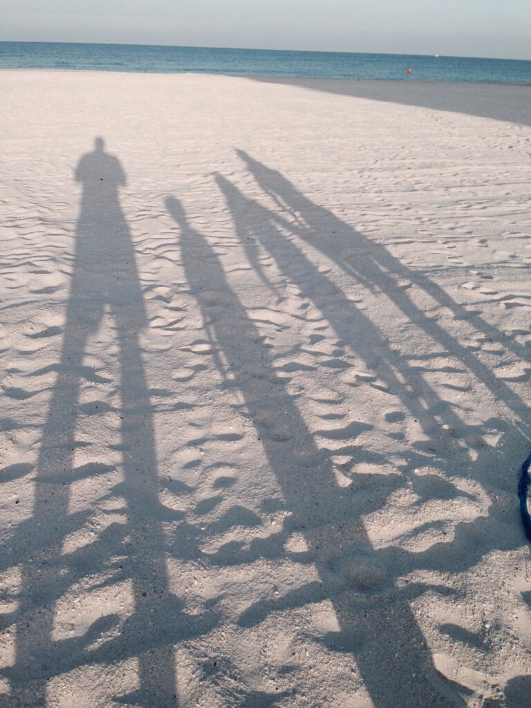 family shadows on beach