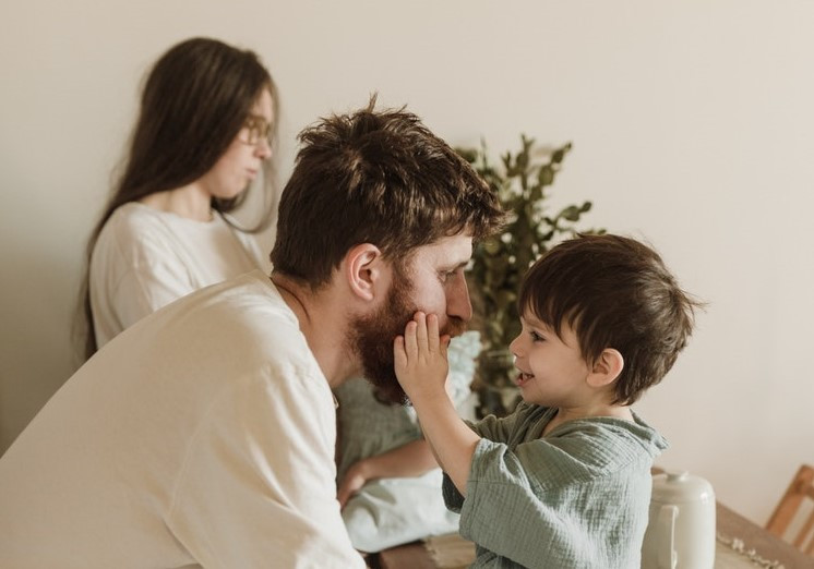 favorite parent boy touches dad face happy