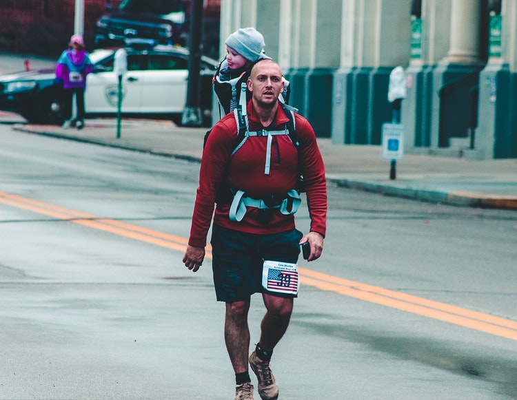 fitness fatherhood running dad child on backpack carrier