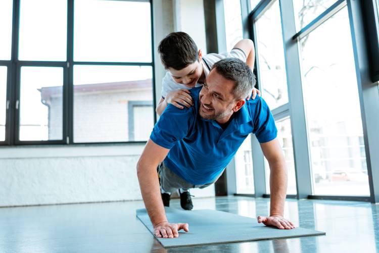 fitness father pushups with son on back