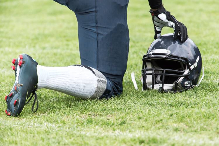 football player kneels national anthem 1