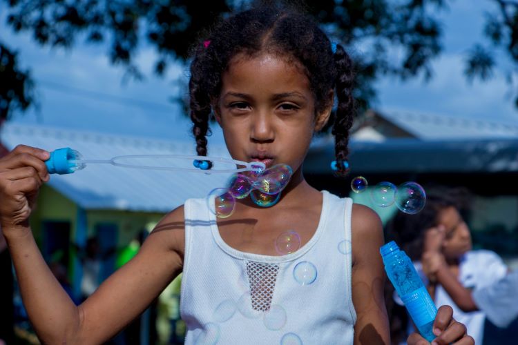 unscheduled summer girl blowing bubbles