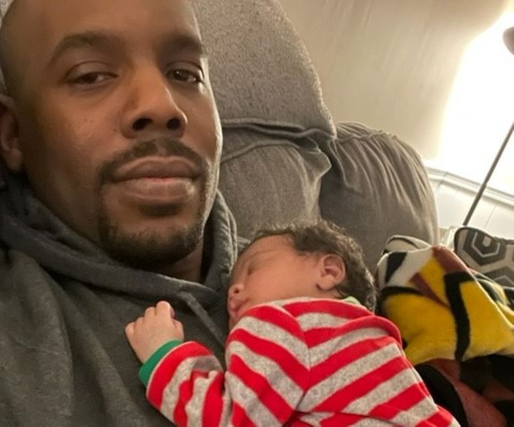 The author Jamar Hudson holds his recently born daughter, making him a second-time father.