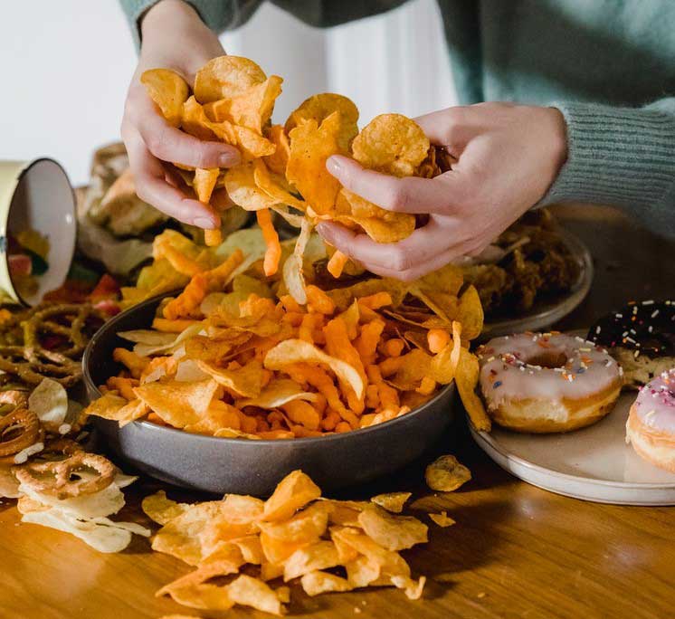 digging hands into chips junk food mafia