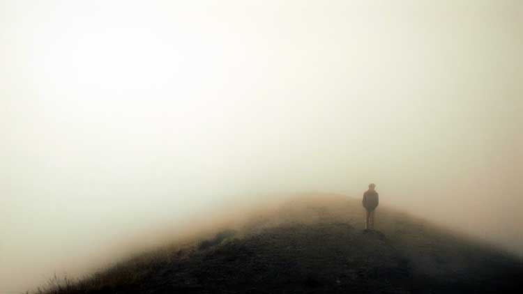 man standing in fog