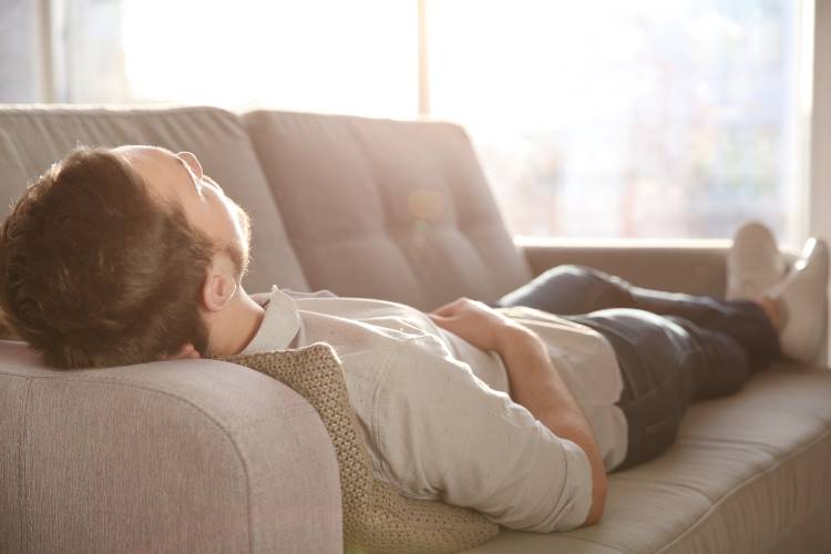 man lies on couch
