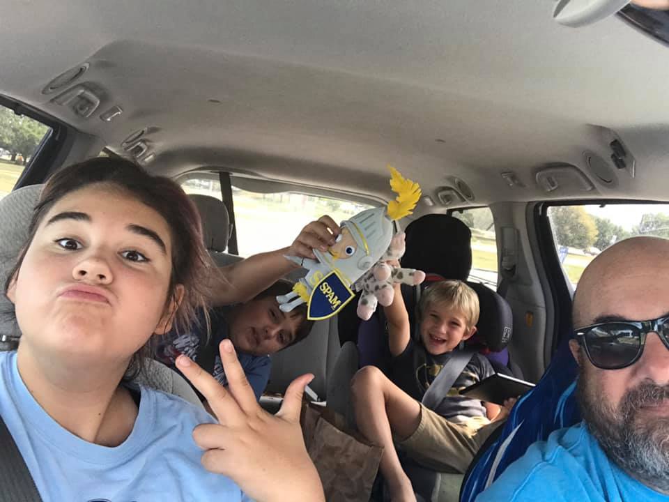 dad's group trip kids in minivan