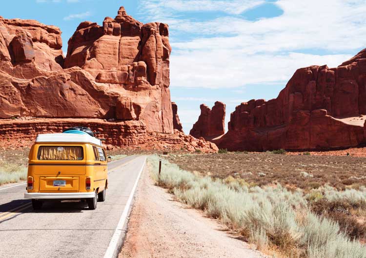 road trip van driving through desert