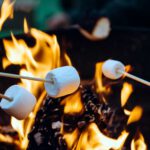 roasting marshmallows over camp fire