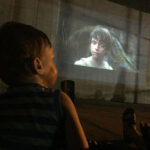 boy watches star wars on screen