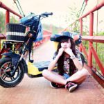 validate teen girls daughter sitting on bridge with bike