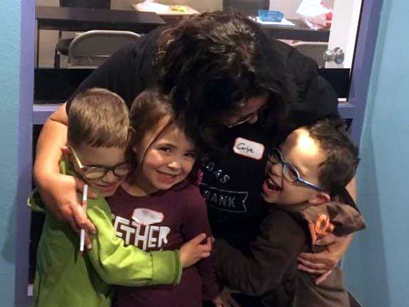 Carlye Davis, executive director of the Las Vegas Diaper Bank, hugs the little helpers from the Vegas Dads Group after they helped with a donation to the National Diaper Bank Network facility. (Contributed photo)